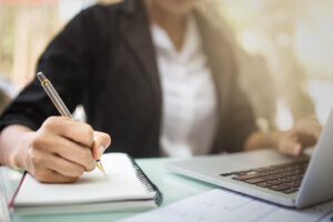 Stock photo of student taking notes. (Courtesy Getty Images)