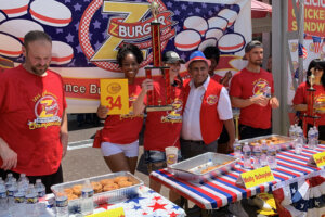 Molly Schuyler accepts her trophy for first place, after eating 34 burgers
