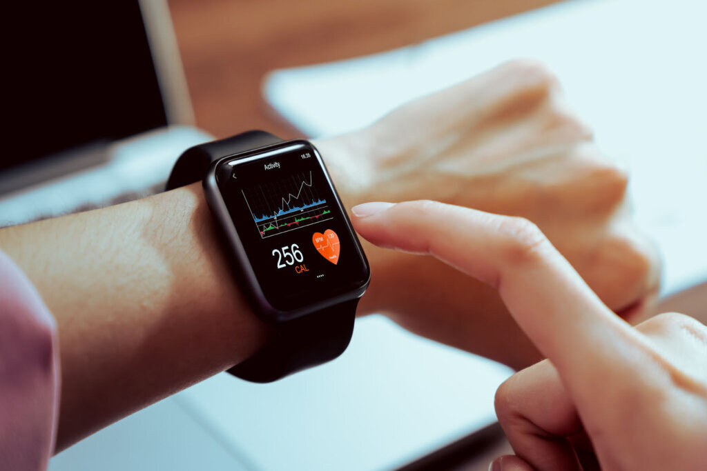 Close up of hand touching smartwatch with health app on the screen, gadget for fitness active lifestyle.