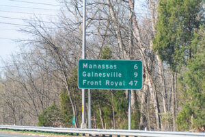 Road sign to Manassas, Gainesville and Front Royal along interstate highway 66 West in state of Virginia