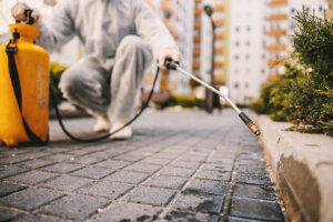 Cleaning and Disinfection outside around buildings, the coronavirus epidemic. Professional teams for disinfection efforts. Infection prevention and control of epidemic. Protective suit and mask.