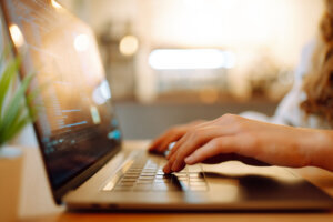 Female hands working on a laptop, close up. Technology, Freelance, online course, remote work and lifestyle concept.