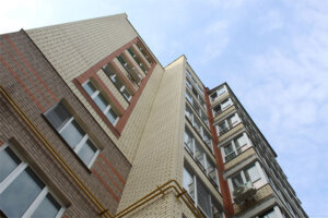 A multi story building shot from the bottom up against the sky.