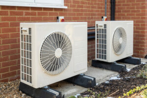 Heat pumps installed on the outside of a modern house