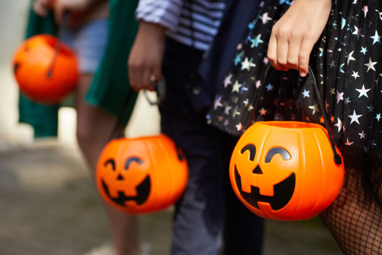 Close up of trick or treaters' candy buckets