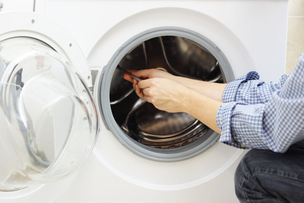 A handyman repairing a washing machine