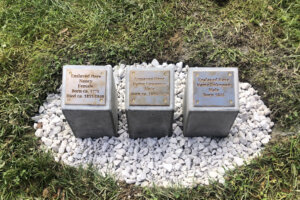 Three bronze plaques made by public school students designed to memorialize the enslaved in Arlington, Virginia, were revealed Saturday. (WTOP/Dick Uliano)