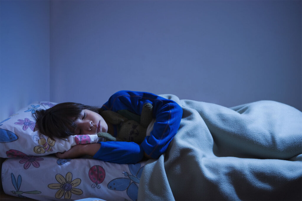 Boy (8 10) sleeping in bed