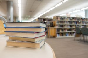 Stack of books on table at library