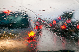 Car windshield in traffic jam during rain.