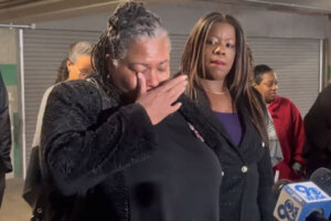 Anthony Evans' mother wipes away tears at a news conference where she's accompanied by Prince George's County State's Attorney Aisha Braveboy