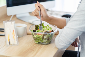 Business women eating salad box and egg sandwich box. eat lunch for work with partnership at workplace.