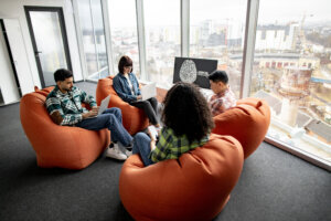 Professionals with gadgets working on AI project in office