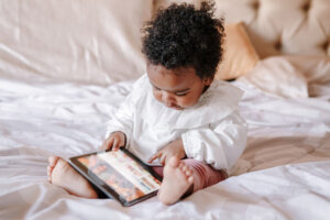 Mixed race African black toddler baby girl watching cartoons on tablet. Ethnic diversity. Little kid child using technology. Early age education development. Video chat or video call.