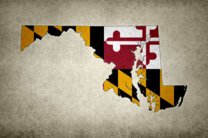 Grunge map of the state of Maryland with its flag printed within