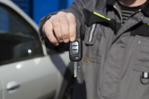 Car keys in the hands of a car mechanic.