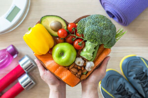 Healthy lifestyle on ketogenic diet, eating clean keto food good health dietary in heart dish with aerobic body exercise, gym workout training class , weight scale and sports shoes in fitness center