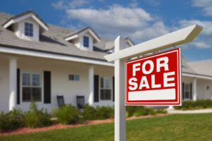 For Sale Real Estate Sign in Front of New House.