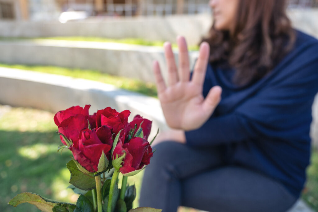 A women rejecting a red roses flower from someone on Valentine's day