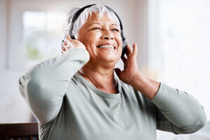 Shot of a beautiful senior woman listening to music while sitting on the sofa at home