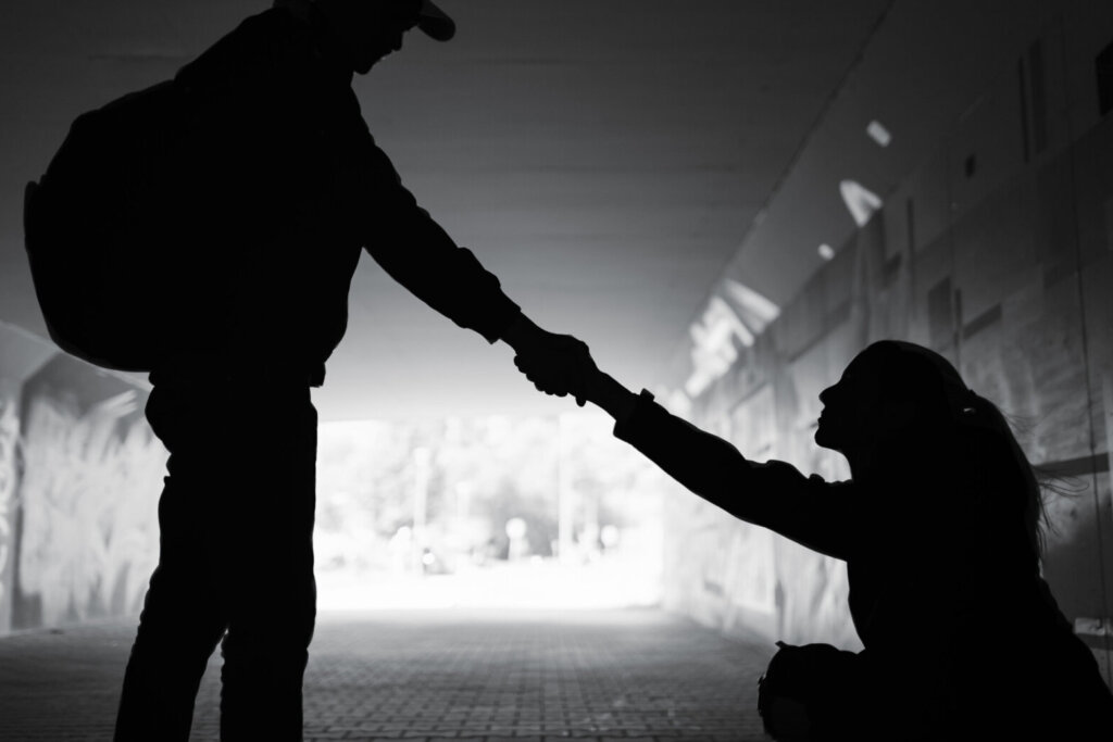 Man giving helping hand woman showing kindness and compassion .