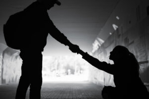 Man giving helping hand woman showing kindness and compassion .