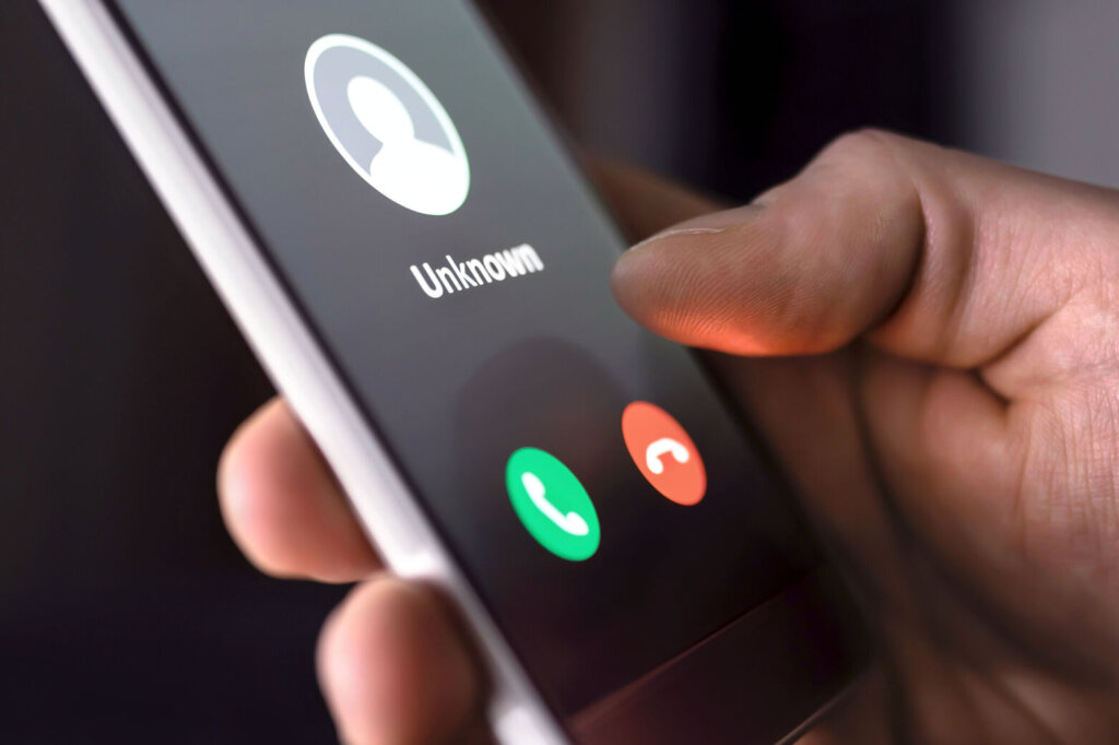 Phone call from unknown number late at night. Scam, fraud or phishing with smartphone concept. Prank caller, scammer or stranger. Man answering to incoming call.