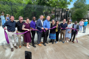 Line of people holding a purple ribbon