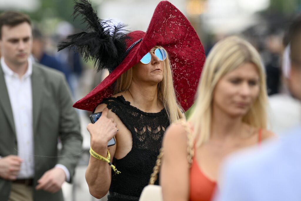 A woman wears a decorative hat