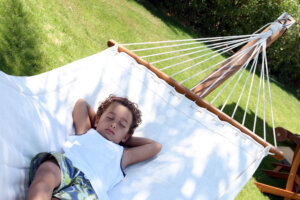 Child laying in a hammock.