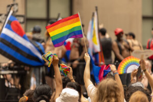 Pride Celebration with Rainbow Flags Waving at a Public Event