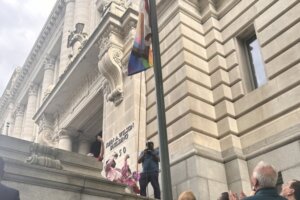 People standing around a flag pole.