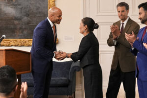 Governor Wes Moore shaking hands with a woman
