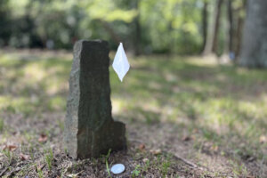White flags mark graves in the cemetery