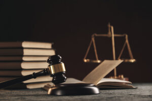 Open law book with a wooden judges gavel