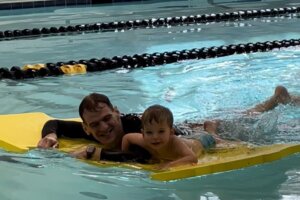 Peter Lord teaching a swimmer