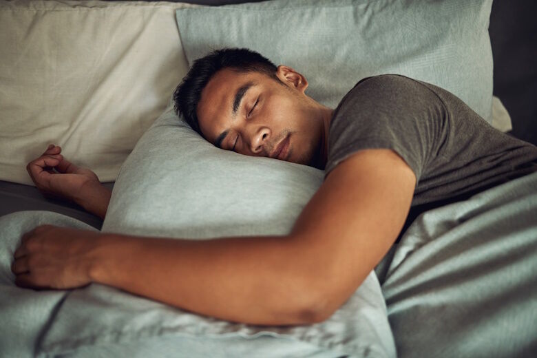 Man asleep in a bed