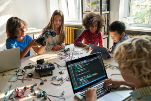 Children work on a project including robotics and computer coding.