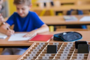 School kids placing putting phones away during class