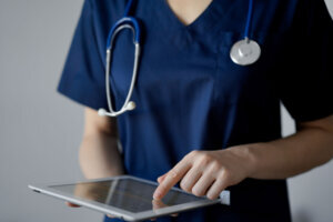 Medical professional using an iPad.