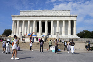 Visitors walk in front of the Lincoln Memorial