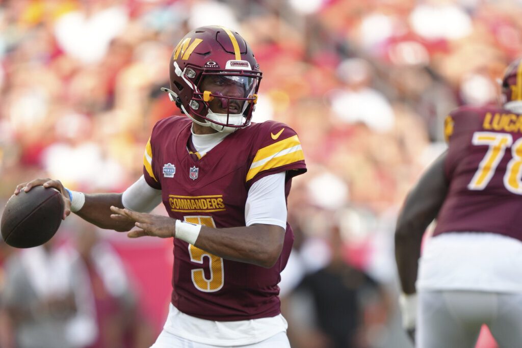 Washington Commanders quarterback Jayden Daniels throws a pass against the Buccaneers