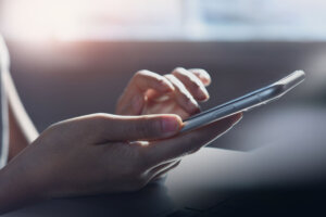 Closeup, woman hand using mobile smartphone, surfing the internet, web browsing via mobile app, social media, network, side view, internet technology, online marketing