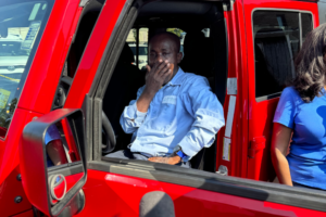 Francis Apraku in his new red Jeep Wrangler