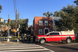First responders in front of fire department vehicle.