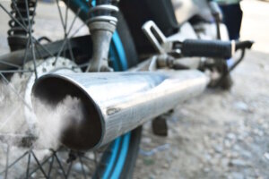 Air pollution from vehicle exhaust pipe close up