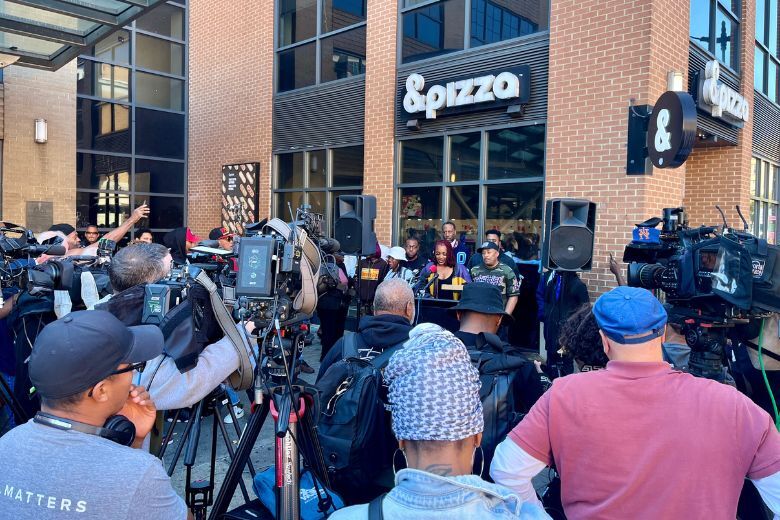 Protesters gathered outside &pizza