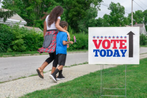 African American mother and son going to vote