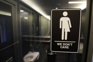 Signage hangs outside a restroom