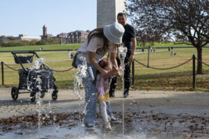 A young family visiting D.C. cooling off